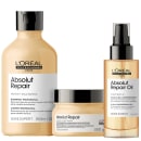 A imagem mostra três produtos da linha Absolut Repair da L'Oréal Professionnel: um shampoo, uma máscara capilar e um óleo capilar.