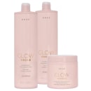 Três produtos da marca Braé: dois frascos de shampoo e condicionador "Glow Shine" em embalagens rosa claro, e um pote de máscara capilar "Glow Shine" na mesma cor.