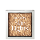 Embalagem quadrada, transparente com bordas prateadas. Nome da linha escrito em letras brancas. É possível ver o produto através da transparência, tem uma cor dourada com padrões em losango.