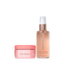 A imagem mostra dois produtos de cabelo da marca Brae. Um é um frasco de óleo brilhante de cor bronze com um aplicador spray branco, da linha Revival. O outro produto é um pote rosa com uma tampa da mesma cor. O rótulo diz "Leave-in Hair Protein".