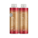São frascos de shampoo e condicionador de 1 litro da linha K-Pak Color Therapy da marca Joico. Os frascos têm formato cilíndrico e tampas brancas. As embalagens apresentam uma combinação de cores com vermelho, dourado e branco.