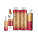 A imagem mostra produtos K-PAK Color Therapy da marca Joico: shampoo e condicionador de 1 litro, máscara de 500ml, leave-in de 200ml e óleo capilar de 63ml. As embalagens apresentam uma combinação de cores vermelha, dourada e branca.