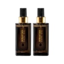 A imagem mostra dois Óleos Capilares Dark Oil da marca Sebastian Professional. Os frascos são pretos, com detalhes em dourado. Apresentam o logotipo e nome da marca "Sebastian Dark Oil" em letras douradas estilizadas.