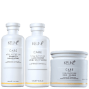 Três produtos da linha Keune Care: shampoo, condicionador e máscara de nutrição vital, em embalagens brancas com logotipo da marca. Os frascos e pote têm design simples e elegante, com informações sobre os produtos impressas em preto.