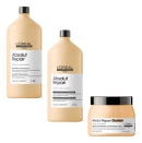 A imagem mostra três produtos da linha Absolut Repair da L'Oréal Professionnel. Dois frascos de 1,5 litros de shampoo e condicionador com proteína e quinoa dourada. Um terceiro produto é uma máscara profissional em um pote plástico bege com tampa preta.