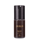Body spray desodorante Dublin, da marca Thera Cosméticos. Embalagem cilíndrica marrom escura com detalhes dourados e parte superior em preto.