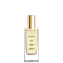 A imagem mostra um frasco de perfume da marca chamada Dream Brand Collection. O frasco é de vidro transparente com detalhes em dourado, incluindo uma tampa cilíndrica dourada. O rótulo indica que a fragrância se chama "Dream No. 021 - Dream by Coconut".