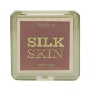 Blush em creme Ruby Rose, chamado "Silk Skin Fresh Face". A embalagem é uma caixa retangular de plástico transparente, com o nome da marca e do produto em letras grandes na parte frontal. A cor predominante do blush é um tom rosado escuro.