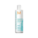A imagem mostra o Condicionador Curl Enhancing 250ml da marca Moroccanoil. É uma embalagem plástica branca opaca com o logotipo da marca em laranja e detalhes do produto em azul turquesa.