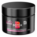 Máscara reestruturadora capilar da linha Botox Capilar da marca Natuflores. Embalagem preta opaca em formato cilíndrico com tampa removível. Rótulo com os dizeres "Botox Capilar" em letras grandes e coloridas.