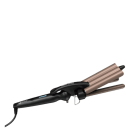 O produto apresentado é um modelador de cabelos da marca Vertix, com design em tons de rosa dourado e preto. Possui três cilindros de aquecimento para criar ondas e cachos no cabelo. O rótulo indica que se trata de um modelo de "Triple Wave