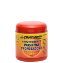 Pote vermelho com tampa amarela contendo "Amazonbronze Parafina Bronzeadora" da marca Pharmakos d'Amazônia, com informações sobre o produto em português.