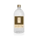 Frasco de vidro transparente com tampa dourada, rótulo dourado com texto "Empório Essenza - Serra Gaúcha", contendo 1 litro de produto.