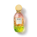 Frasco de perfume O.U.i. com design escultural em tons de rosa, amarelo e verde. Rótulo com nome da marca e informações sobre a fragrância "Madeleine 922 La Pistacherie".