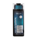 A imagem mostra um frasco de shampoo com uma tonalidade preta e rótulo com fundo azul escura. Traz informações na cor cinza e preta. O tamanho do frasco é de 300ml ou 10,1 fl.oz.
