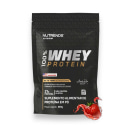 Suplemento alimentar de proteína em pó da marca Nutrends, da linha Elite Series. A embalagem é um pacote preto com o logotipo da marca e a informação de que se trata de "100% Whey Protein", com 21g de proteína por porção.