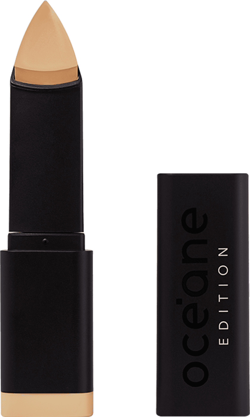 A imagem mostra a Base em Bastão Océane Edition Foundation Stick: embalagem preta com o logotipo "Océane Edition" impresso em relevo na parte frontal. A base tem formato triangular.