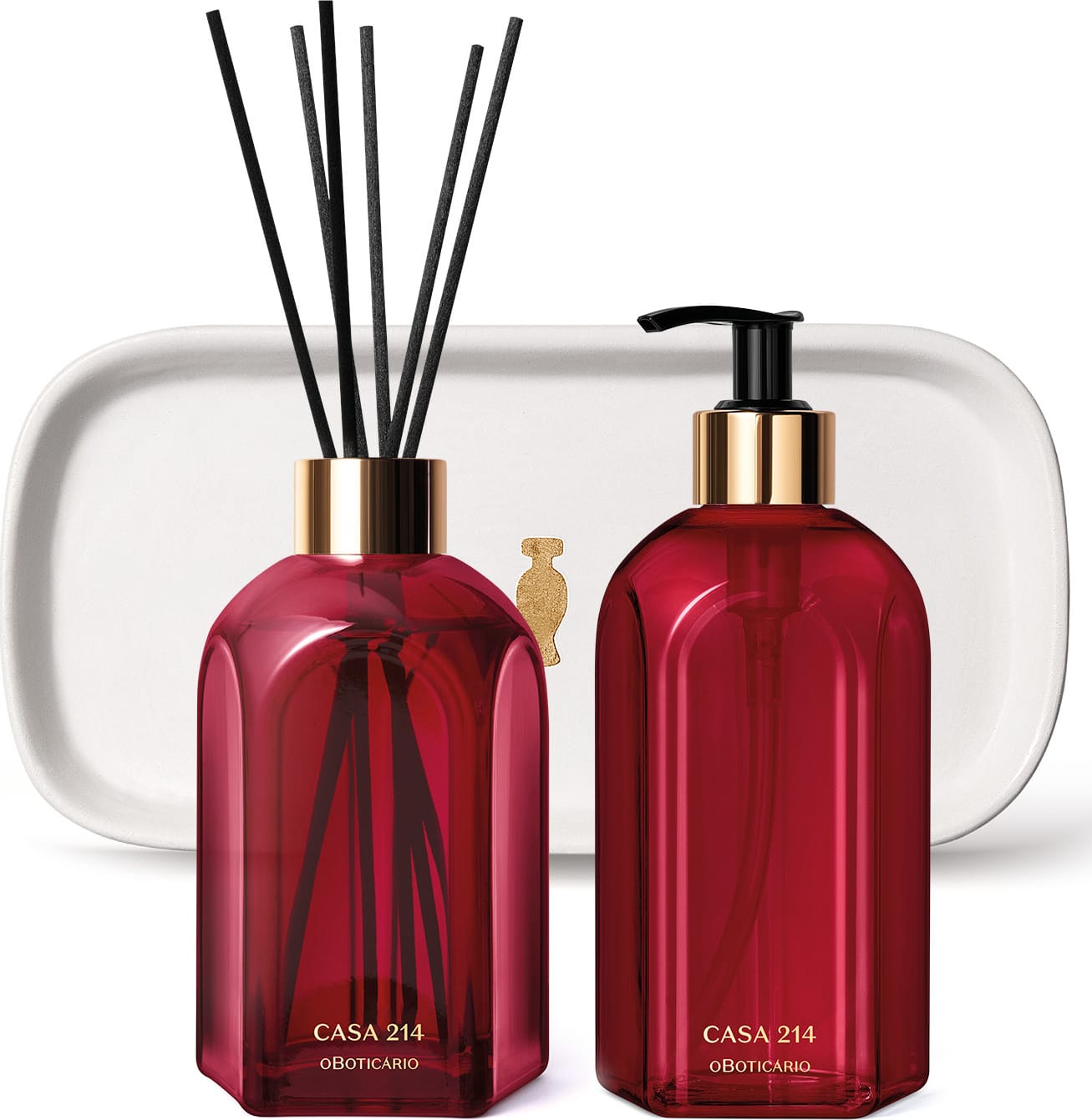 Três produtos da marca Casa 214 Gardênia Imperial: dois vidros vermelhos, sendo um difusor de ambientes com valetas e o outro com bico dosador preto de sabonete líquido e uma badeja de lavabo branca com logo da marca O Boticário em dourado.