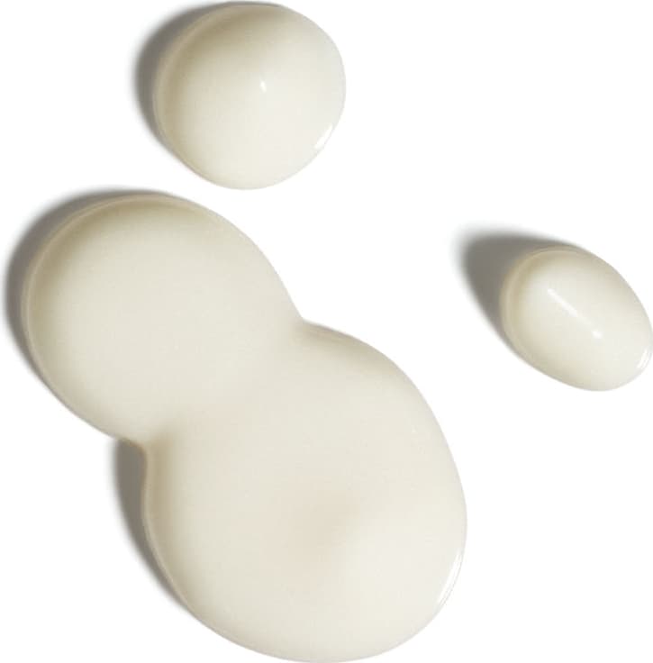 Textura branca e cremosa do protetor solar facial antioxidante FPS 70 Ultra Fluído da marca Boti.Sun, de aparência fluída e brilhante espalhada em superfície branca.
