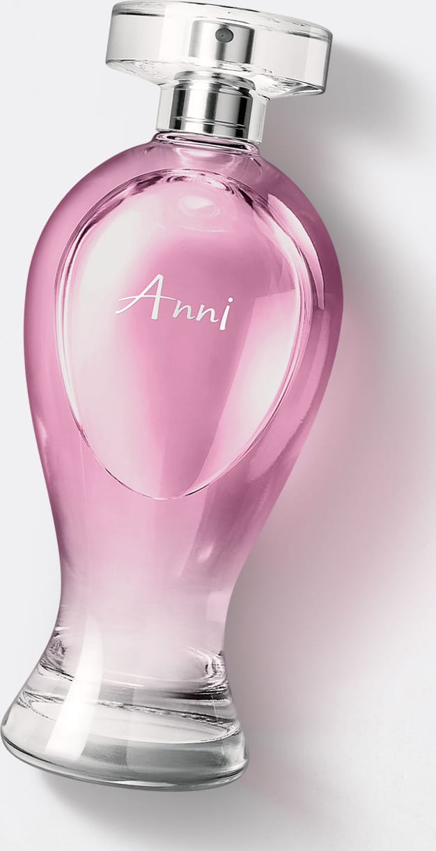 Vidro transparente em formato curvilíneo com líquido rosa, pulverizador prateado e tampa transparente contendo 200ml de desodorante colônia Boticollection Anni em um fundo cinza.