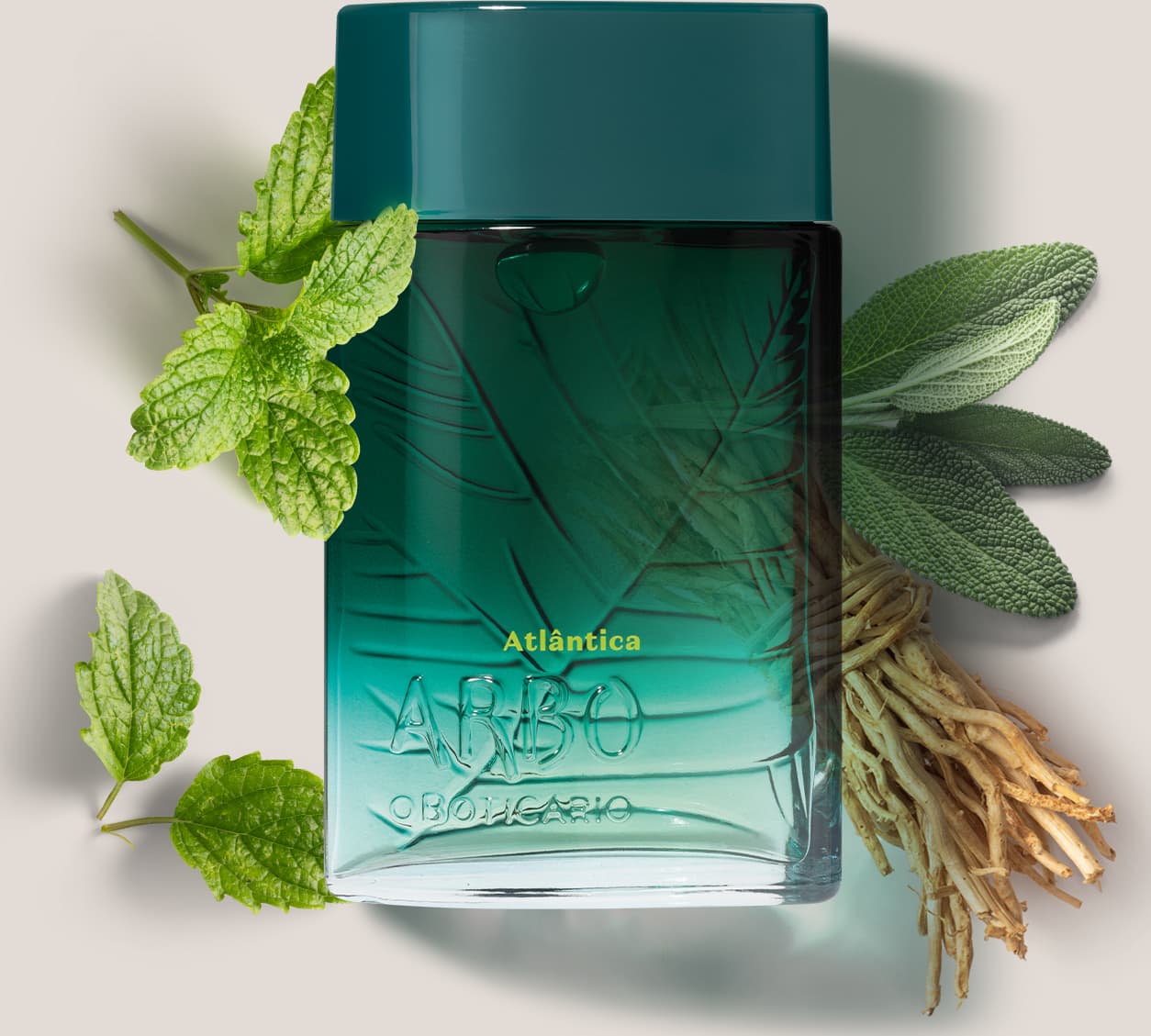 Frasco de desodorante colônia Arbo Atlântica, com design verde degradê e textura de folhas, apresentado com folhas de hortelã e raízes secas.