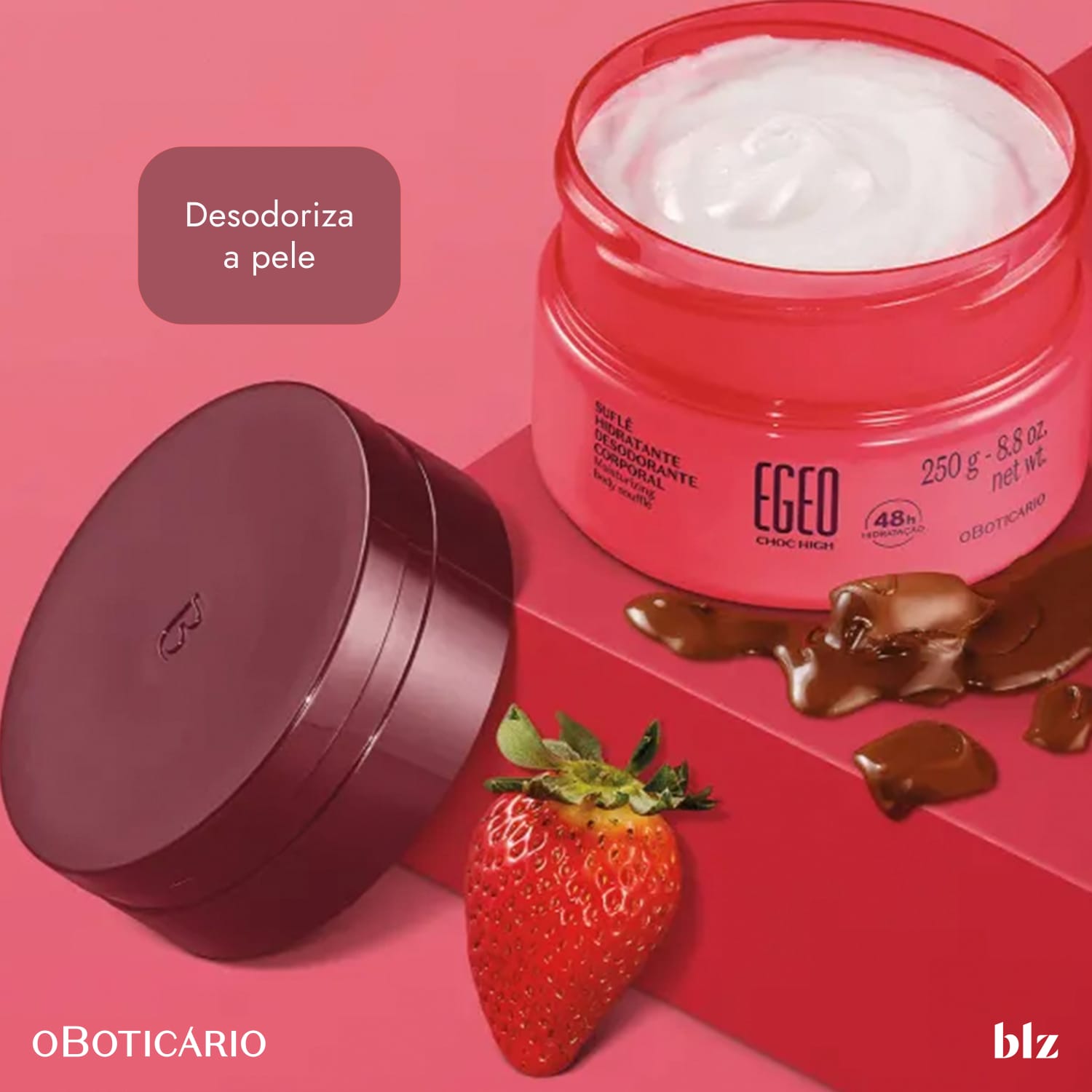 Recipiente de creme de cor rosa com rótulo "Egeo" em fundo rosa. Ao lado, uma morango e chocolates. Ambiente sugere contexto de cuidados com a pele e beleza.