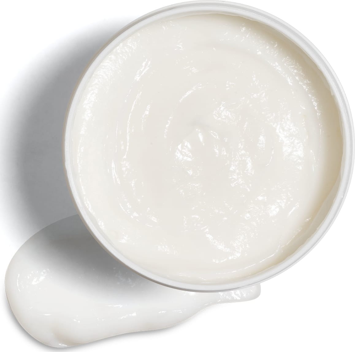 Imagem de um pote branco aberto contendo creme branco dentro e um pouco do mesmo produto no fundo da imagem.
