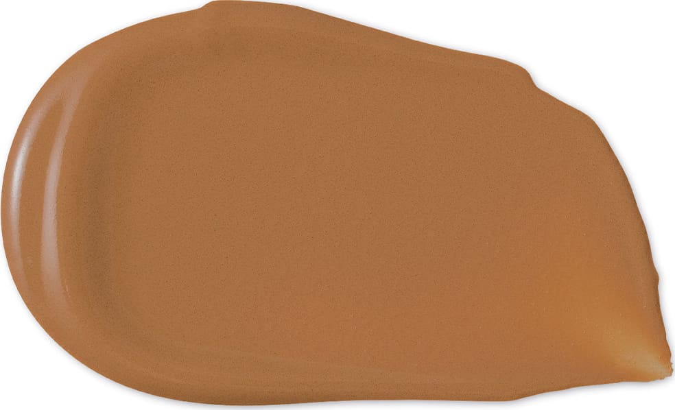 O produto de beleza apresenta uma textura cremosa e brilhante, com uma coloração marrom dourada uniforme. Sua aparência sugere uma consistência suave e aveludada, típica de produtos de maquiagem de alta qualidade.
