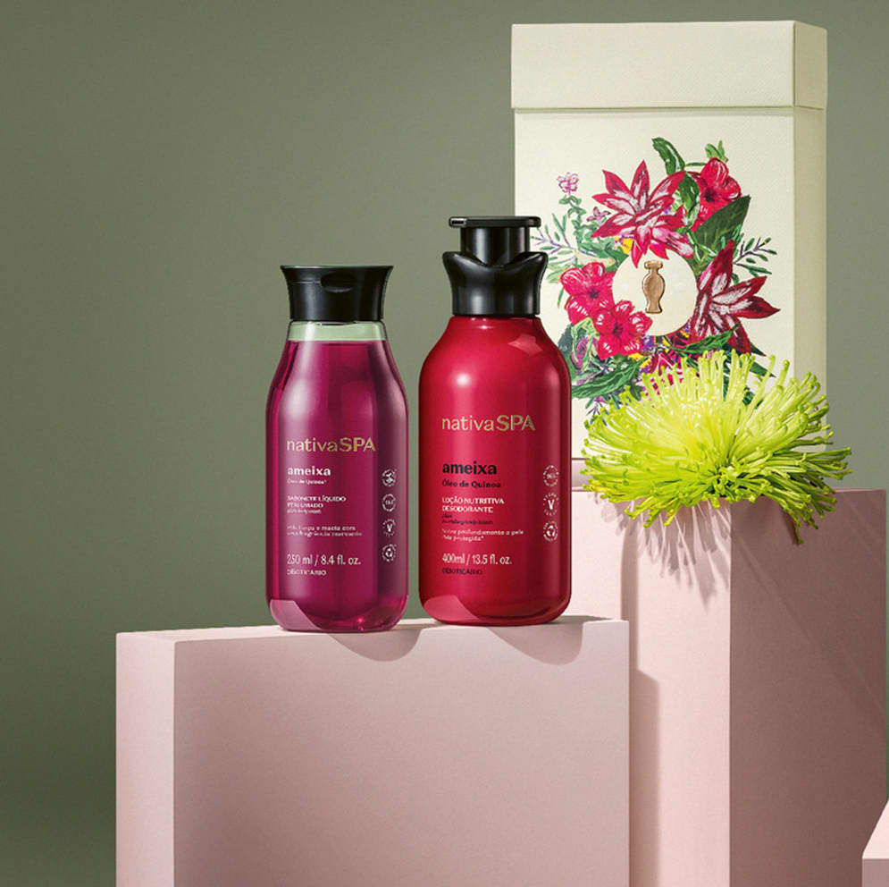Imagem de kit de presente Nativa SPA Ameixa contendo  um frasco de sabonete líquido, outro de loção desodorante corporal e uma caixa branca com ilustração floral. O kit está sobre quadrados brancos com fundo cinza.