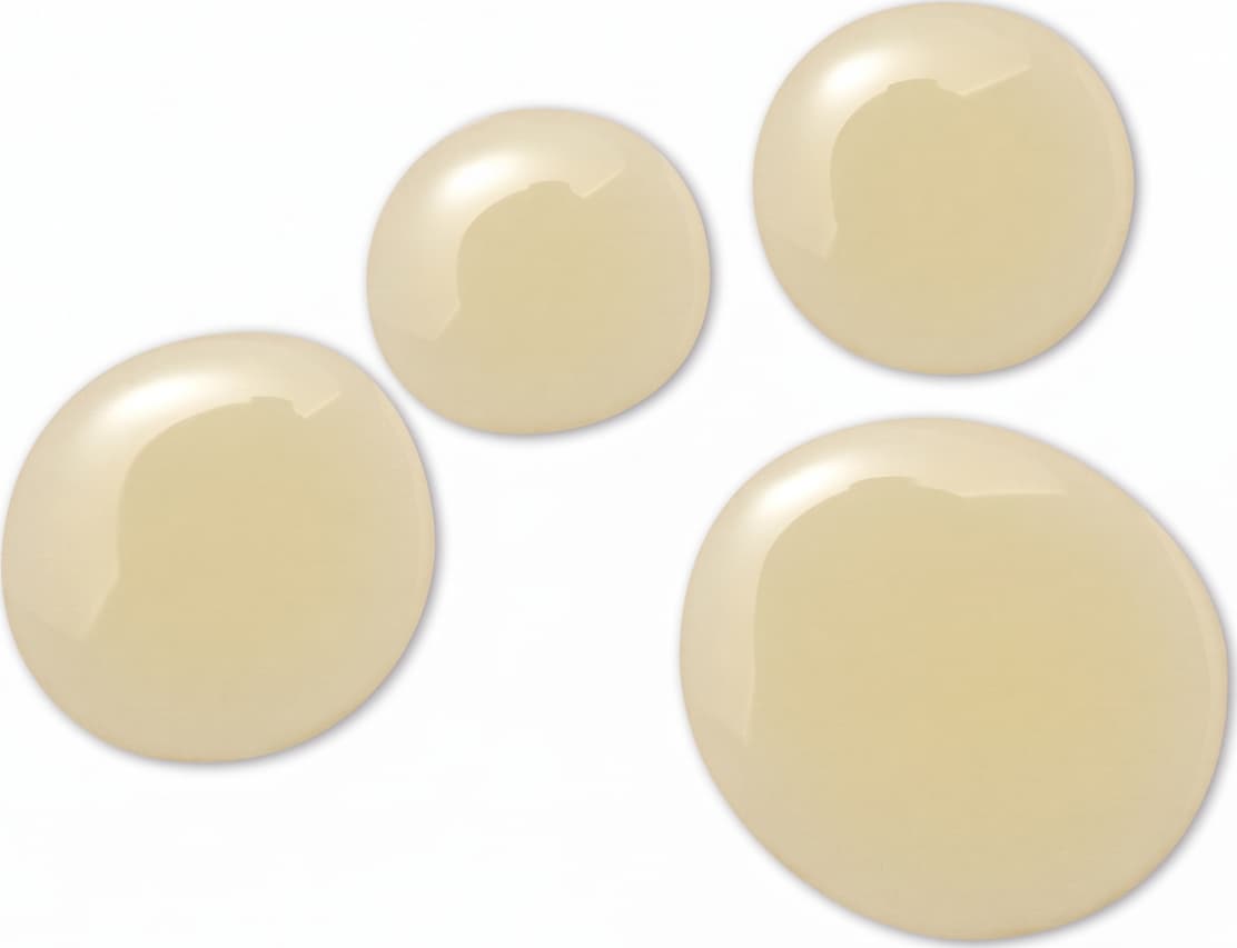 Quatro gotas de produto de produto com textura em óleo de cor bege sobre superfície branca.