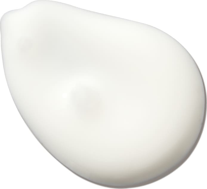 Textura do protetor solar. É branco com uma forma arredondada e irregular, em uma textura leve e cremosa. Não há rótulos ou textos visíveis na imagem, apenas a superfície branca e lisa da textura.