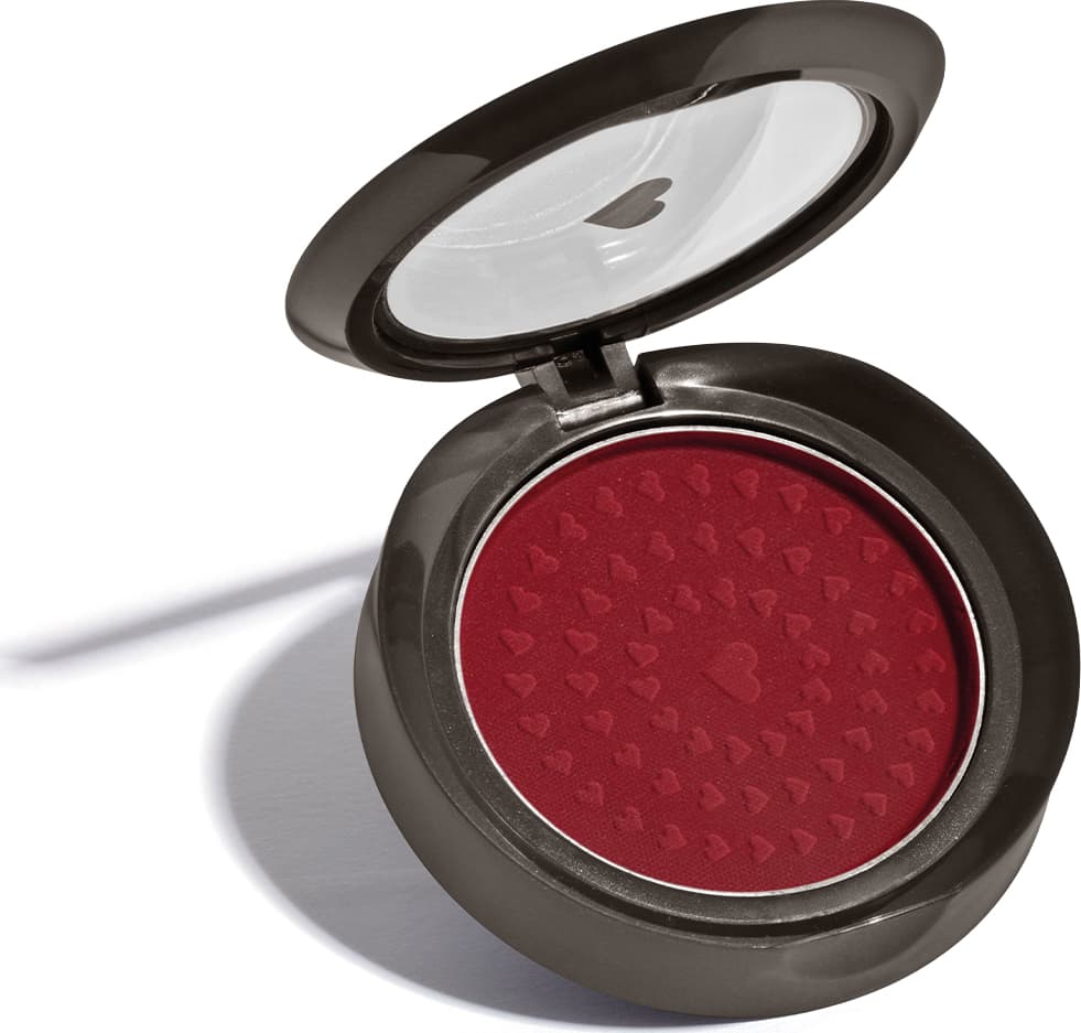 Estojo compacto redondo na cor preta com tampa transparente com coração ilustrado contendo 2g de blush em pó compacto Rubor Vermelho Vermetin da marca Quem Disse, Berenice?.