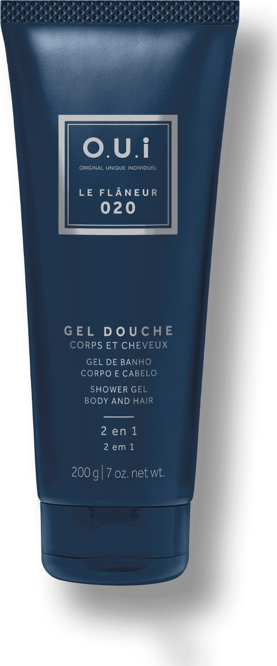 Embalagem tubo plástico azul marinho opaco metálico com tampa texturizada. Rótulo retangular branco com o nome da marca e linha em letras maiúsculas. Informações do produto em francês e inglês, incluindo peso líquido de 200g.