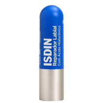 Produto de beleza ISDIN em embalagem cilíndrica azul e branca, com o nome "ISDIN Reparador Labial" impresso. O produto parece ser um bálsamo labial ou protetor labial.