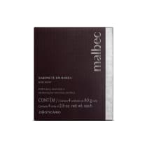 O produto apresentado é um sabonete em barra da marca Malbec. A embalagem é retangular, com uma superfície texturizada em tom escuro marrom/vinho. O rótulo contém o nome da marca "Malbec" em destaque, além de informações sobre o produto.