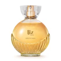 Frasco de fragrância Liz  da marca O boticário, com formato arredondado e detalhes em dourado, contendo um líquido âmbar em seu interior.