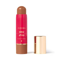 O produto apresentado é um contorno em bastão da linha Niina Secrets. A embalagem é cilíndrica e de cor rosa vibrante, com o nome da marca e da linha impressos em letras douradas. A embalagem também possui um detalhe dourado na parte superior.