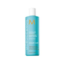 A imagem mostra o Shampoo Moroccanoil Color Care 250ml. O frasco é na cor azul turquesa, com as letras em branco e laranja. O rótulo destaca que é um shampoo para cabelos coloridos para preservar a cor e brilho, livre de sulfatos, fosfatos e parabenos.