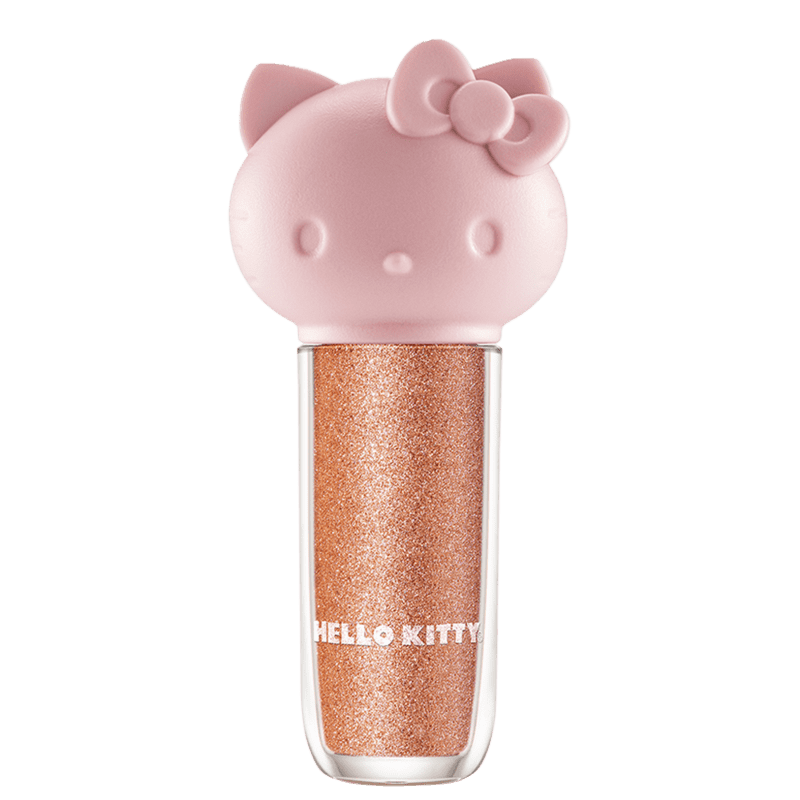 Maquiagem em formato cilíndrico com a cabeça da personagem Hello Kitty como tampa. A parte superior é rosa com detalhes em relevo que representam os olhos, orelhas e laço da Hello Kitty. É possível ver a cor do produto pelo corpo transparente.