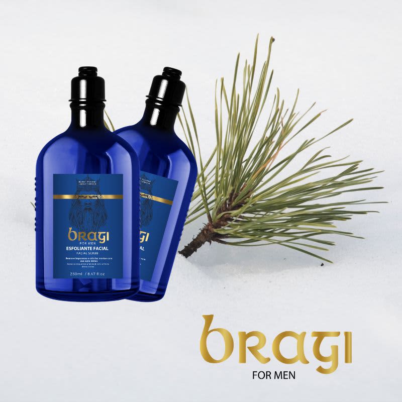 A imagem mostra dois frascos em tom azul escuro com detalhes dourados em um fundo neutro. Ao lado dos frascos, há um galho ou ramo de uma planta real, provavelmente relacionada aos ingredientes naturais utilizados no produto.