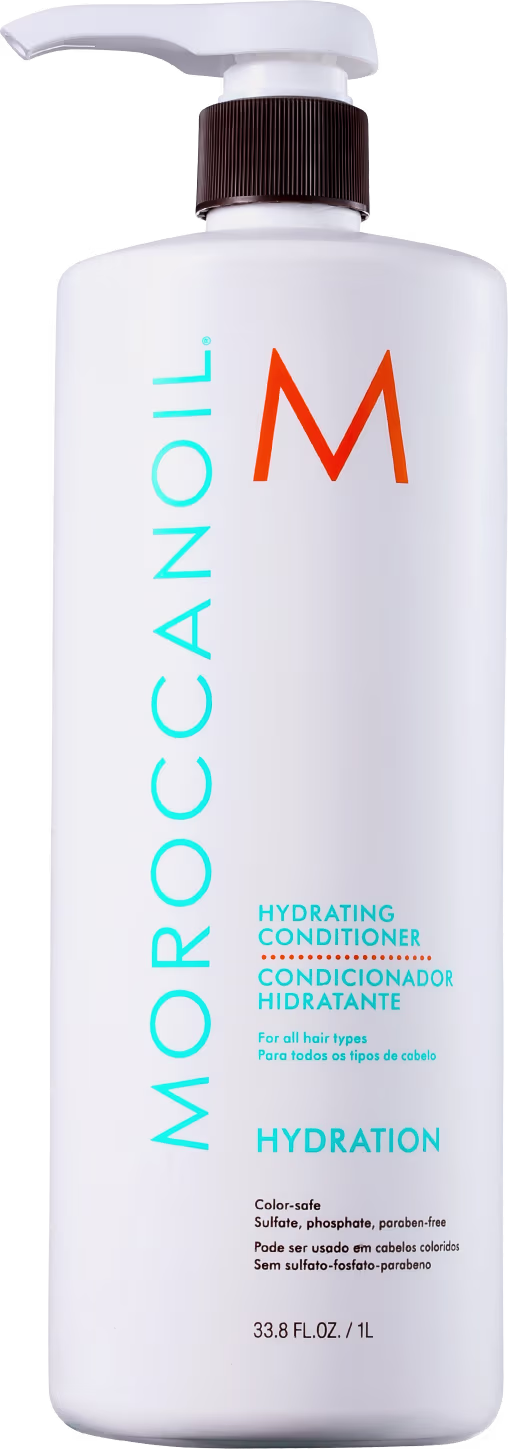 A imagem mostra o Condicionador Moroccanoil Hydration 1L. O frasco é branco com letras em azul vibrante, laranja e preto. O rótulo destaca que é um "Condicionador Hidratante" para todos os tipos de cabelo, livre de sulfatos, fosfatos e parabenos.