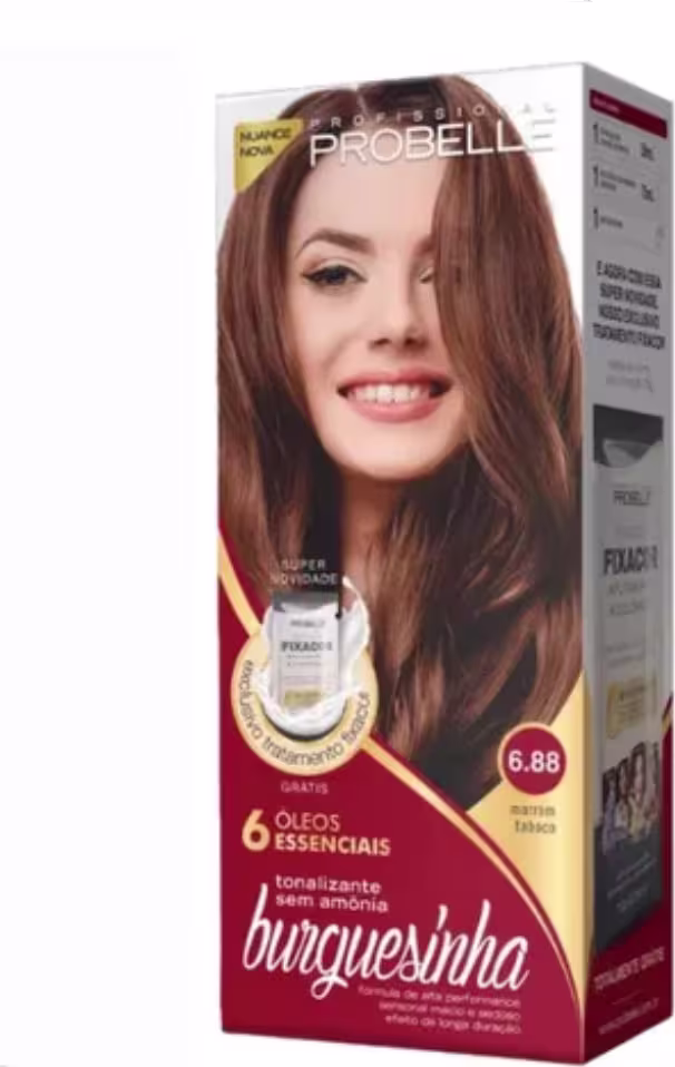Produto de coloração de cabelos da marca Probelle. Caixa retangular vermelha com detalhes dourados. Imagem frontal de uma mulher sorridente com cabelos longos e castanhos. Rótulo indicando "6 Óleos Essenciais" e  tonalidade 6.88 marrom tabaco.