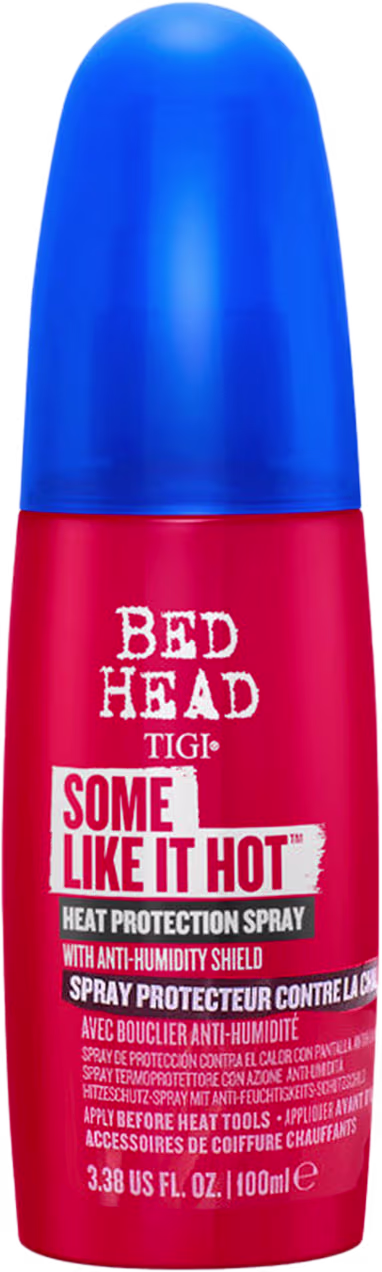 Frasco de spray protetor térmico da linha Bed Head da TIGI, com design em azul e vermelho, contendo o texto "Some Like It Hot" e informações sobre proteção contra umidade.