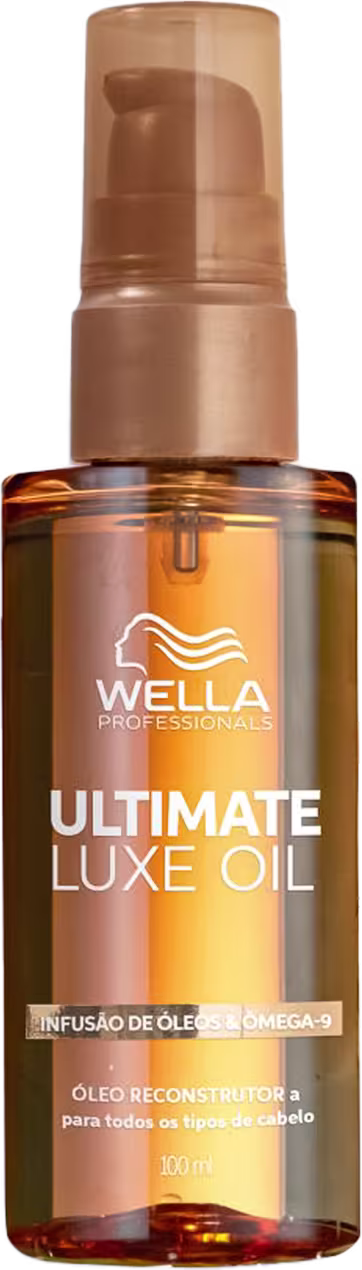 Óleo capilar em um frasco de vidro âmbar com aplicador em formato de bomba pump na cor bege. Rótulo com o nome do produto e a marca em letras brancas. Tamanho de 100ml.