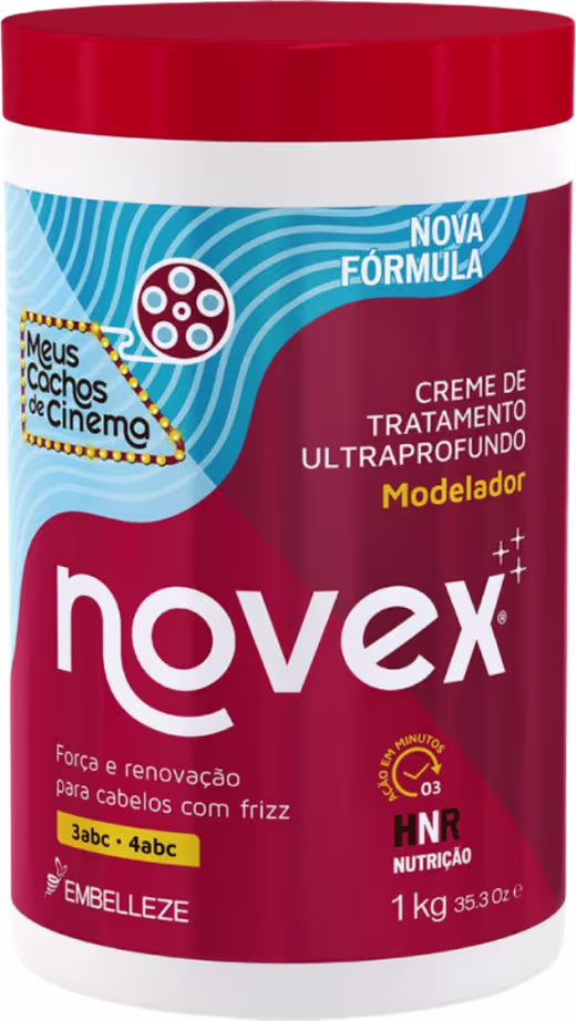 A imagem mostra o Creme de Tratamento Modelador Meus Cachos de Cinema 1kg, da marca Novex. O pote é vermelho com detalhes em branco e azul claro. O rótulo destaca que o produto promete "Força e renovação para cabelos com frizz" .