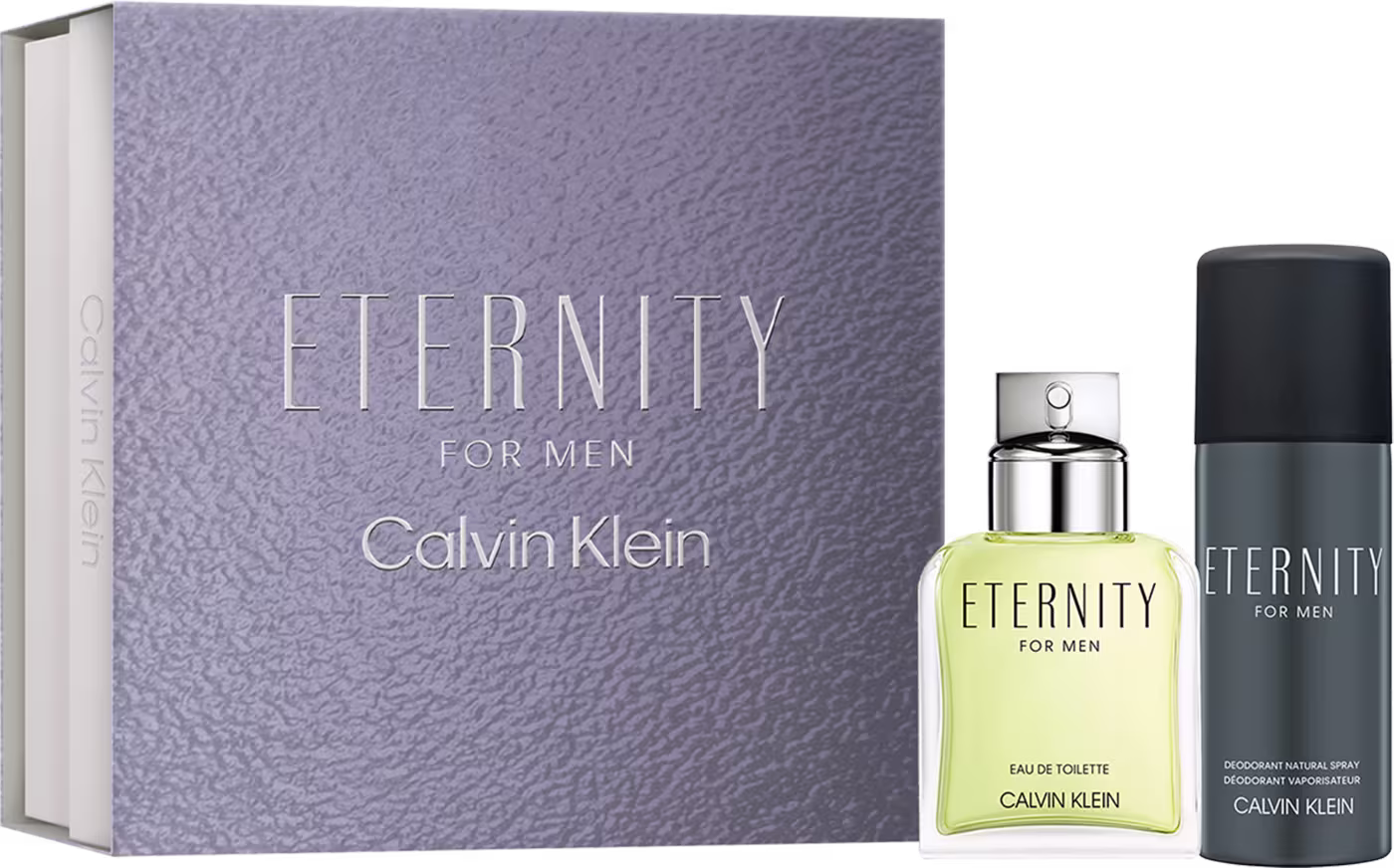 Caixa retangular cor cinza texturizada com "Eternity for Men" em relevo. Frasco de perfume em vidro transparente com líquido amarelo claro e tampa prateada. Desodorante spray preto cilíndrico com rótulo "Eternity for Men".