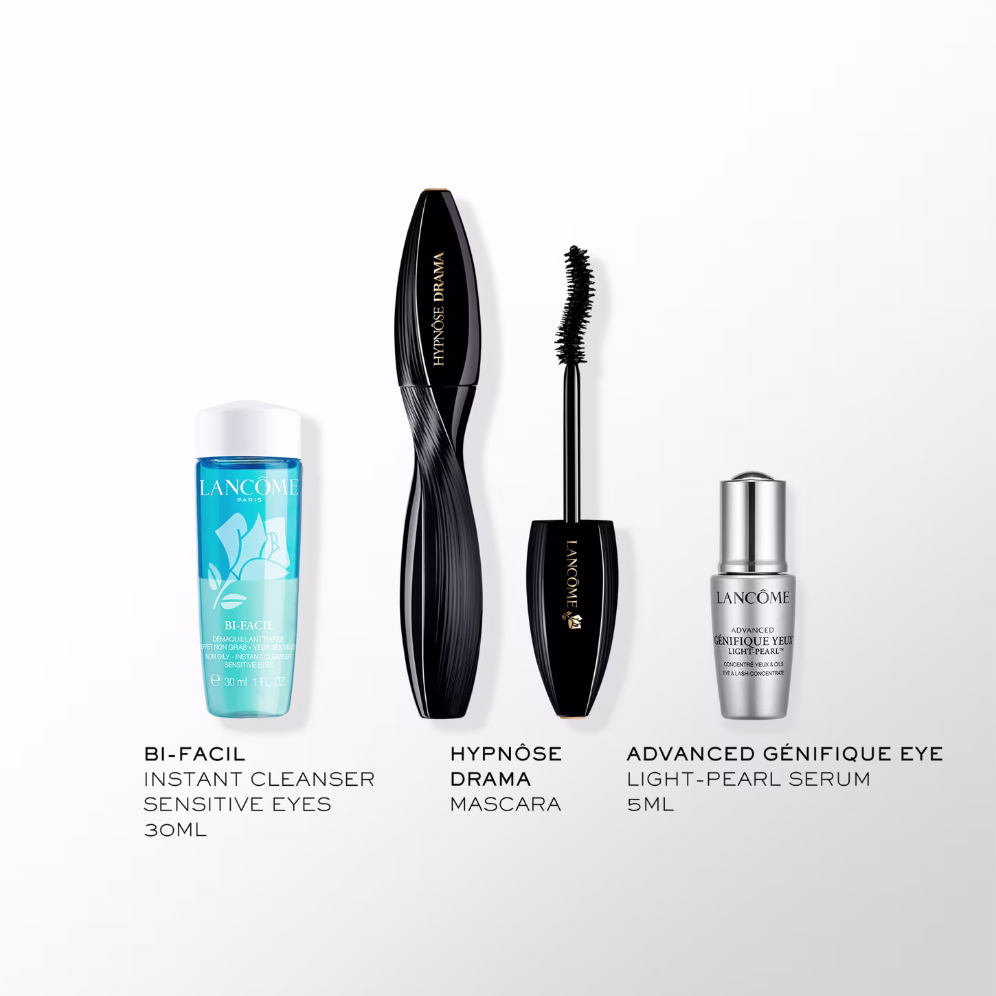 A imagem mostra três produtos da marca Lancôme. O primeiro é chamado "Bi-Facil Instant Cleanser Sensitive Eyes". O segundo é uma máscara de cílios "Hypnôse Drama Mascara". O terceiro é um sérum para olhos, chamado Génifique Eye.