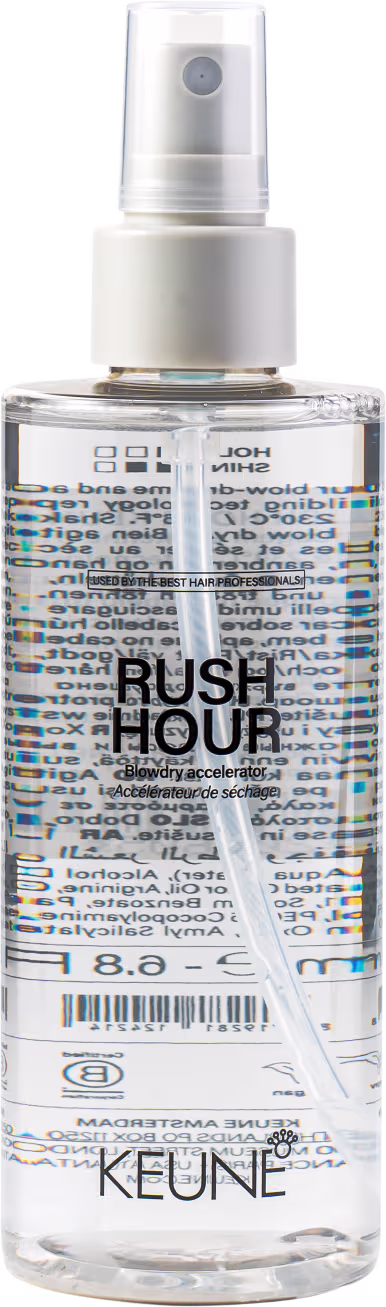 A imagem mostra o Spray Acelerador de Secagem Rush Hour da marca Keune. Embalagem transparente de plástico em formato cilíndrico com um aplicador borrifador.