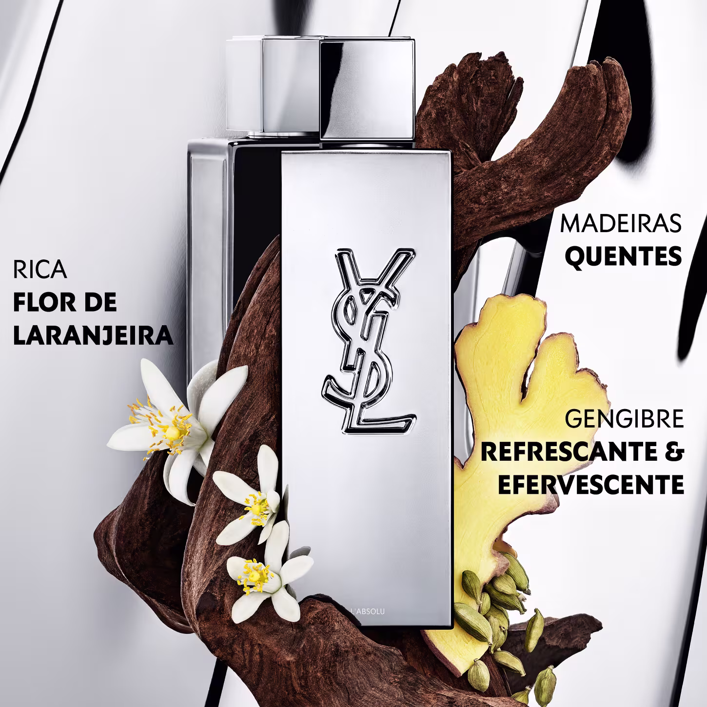 Frasco de perfume de design minimalista prateado, com o logotipo da marca Yves Saint Laurent em destaque. A embalagem possui uma forma geométrica simples e elegante, com uma tampa destacada no topo.