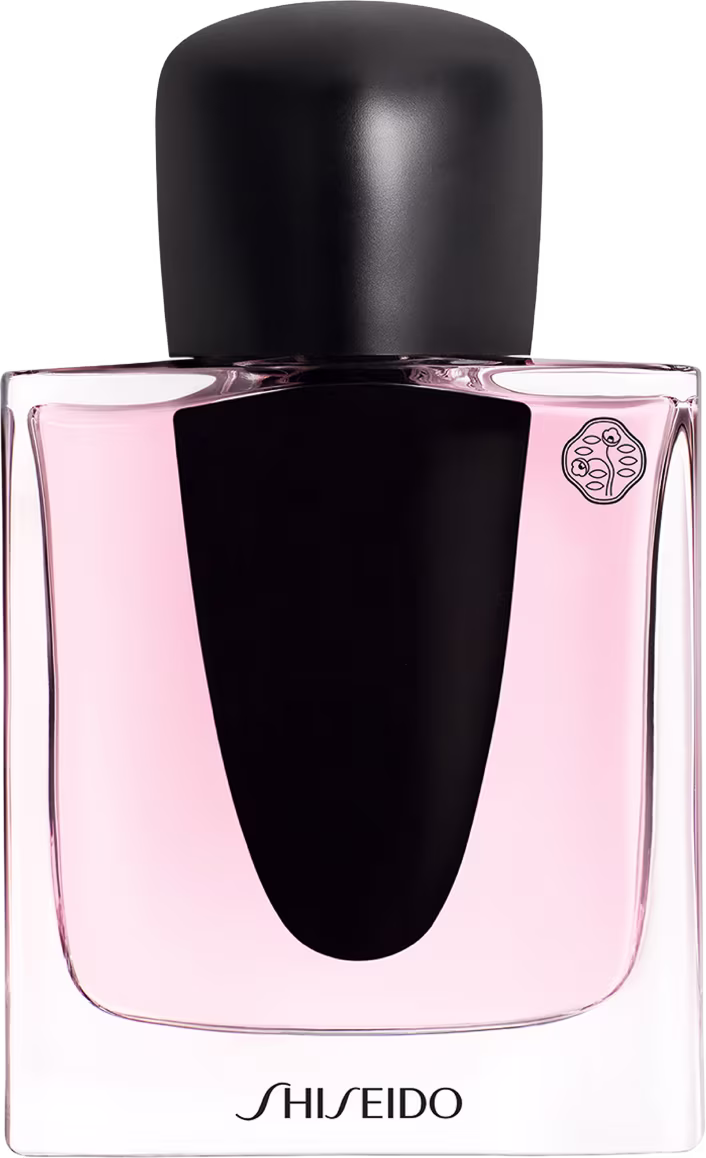 Frasco de perfume Shiseido de design elegante, com tampa preta e corpo de vidro rosa claro. O rótulo apresenta o nome da marca em destaque. Embalagem sofisticada e minimalista, com foco na essência do produto.